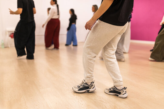 Dance students legs practicing choreography in studio