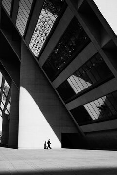 Silhouette Under Brutalist Facade Dallas city Hall