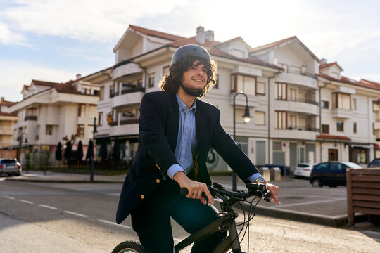 Young man commuting by bicycle to business meeting
