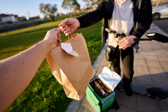 Food delivery service courier handing over order