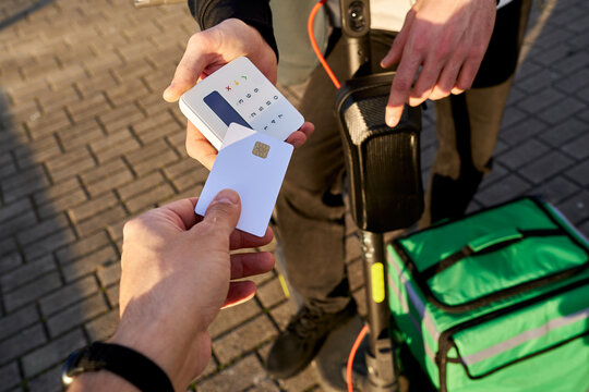Food delivery rider accepting contactless card payment