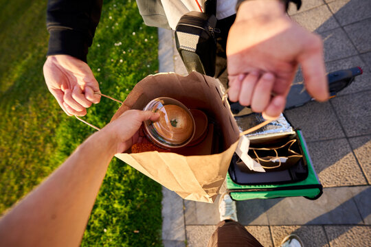 Food delivery service delivering fresh bagel in paper bag