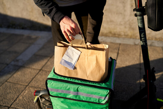 Food delivery service courier preparing customer order