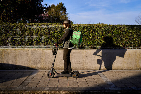 Food delivery rider on electric scooter urban transport