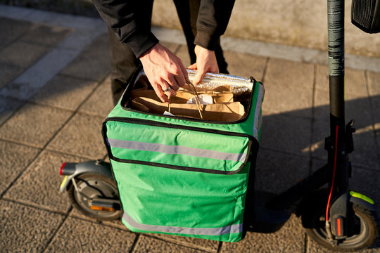 Food delivery rider preparing takeaway order for delivery