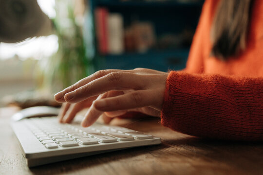 Close View of Woman Typing on Keyboard in Home Office