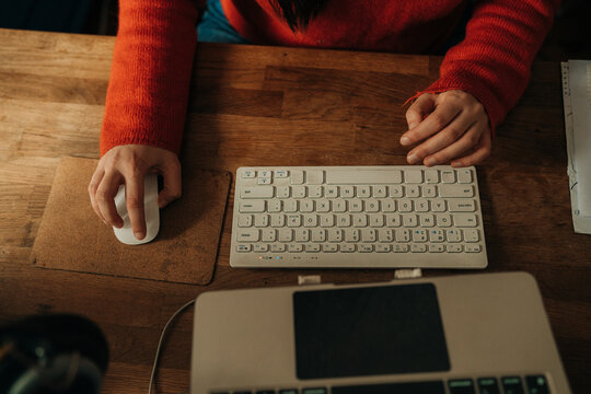 Female Hands Using Keyboard and Mouse at Wooden Desk