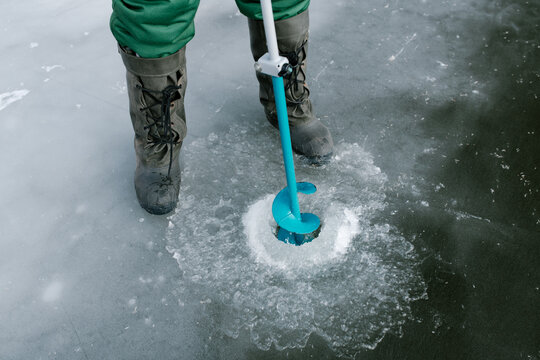 Fisherman Using Hand Auger