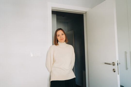 Woman Standing in Minimal Interior Doorway