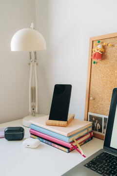 Smartphone on Books Stack in Home Office
