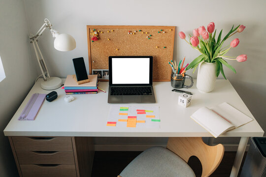 Organized Home Office Desk with Laptop and Tulips