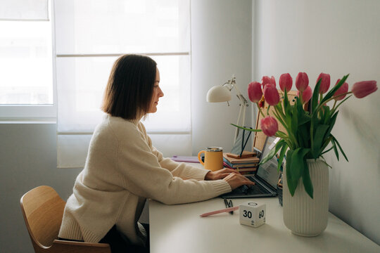 Woman working on laptop at home