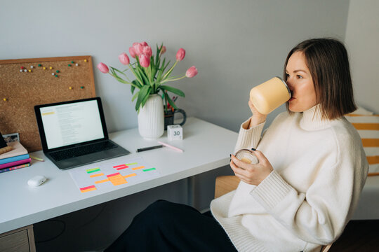 Woman Drinking Coffee at Home Office Desk