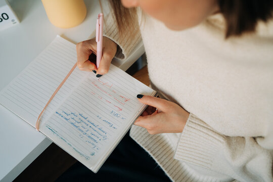 Close Up of Female Hand Writing in Journal