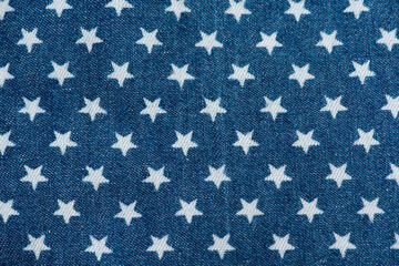 Old blue denim and printed star pattern background. © wasanajai