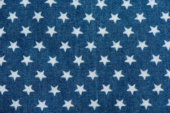 Old blue denim and printed star pattern background.