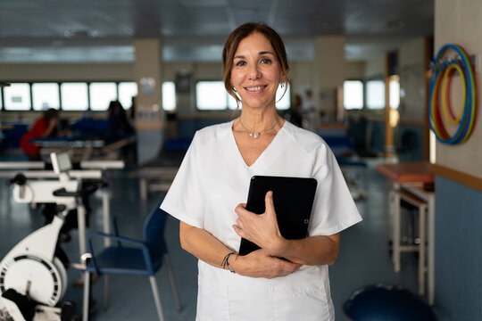 Medical professional holding a digital tablet in rehabilitation center