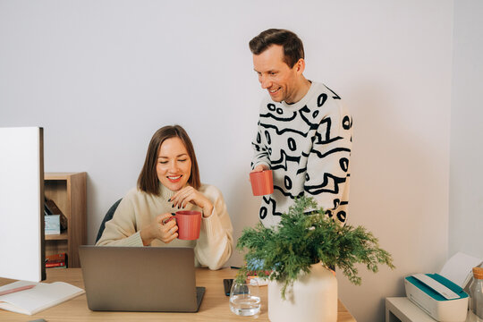 Smiling Couple Enjoying Coffee Break During Remote Work