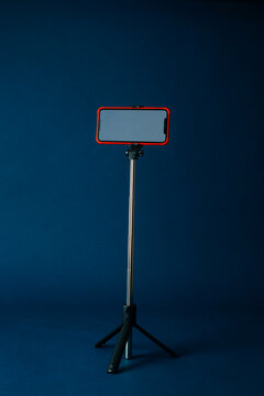 a telescopic tripod holding a smartphone