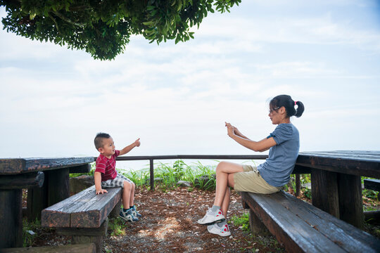 Mother Taking Photo of Son During Family Travel
