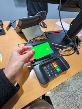 Woman paying with credit card using terminal