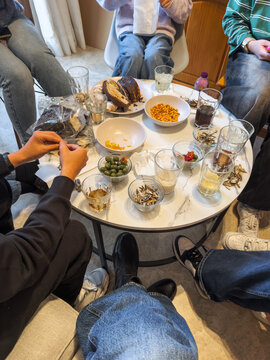 Round table with snacks and drinks at home gathering