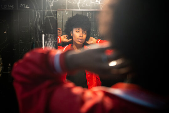 A black woman in the bathroom of a party 