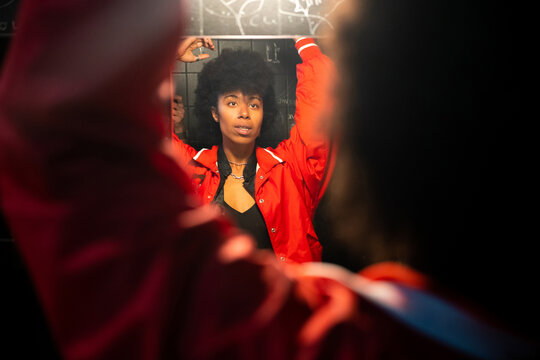 A black woman in the bathroom of a party 