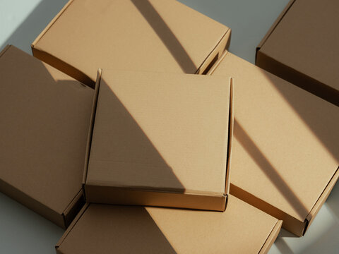 Stack of cardboard boxes with dramatic sunlight and shadow