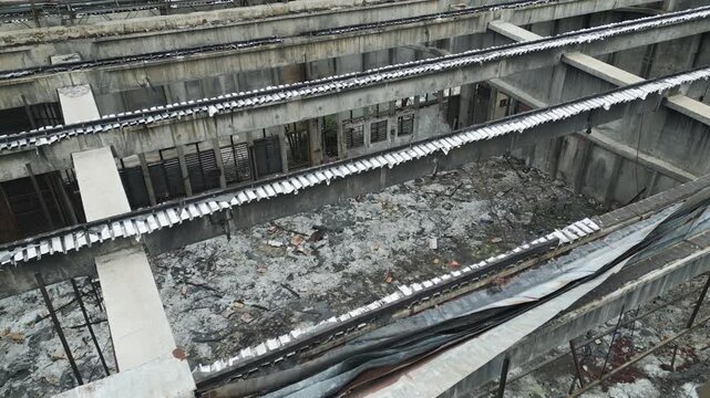 Derelict industrial site in Eastern Europe with collapsed roof, aerial perspective