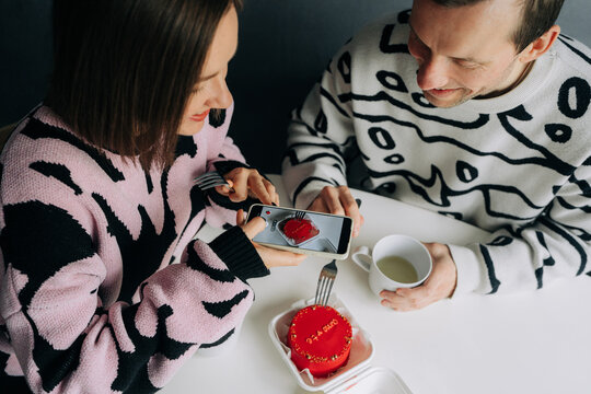 Woman Photographing Red Cake with Smartphone