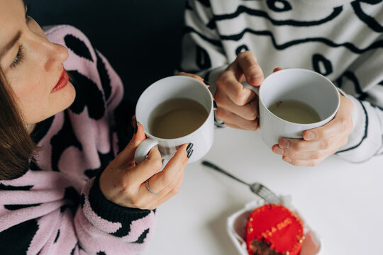 Closeup of Couple Holding Tea Cups