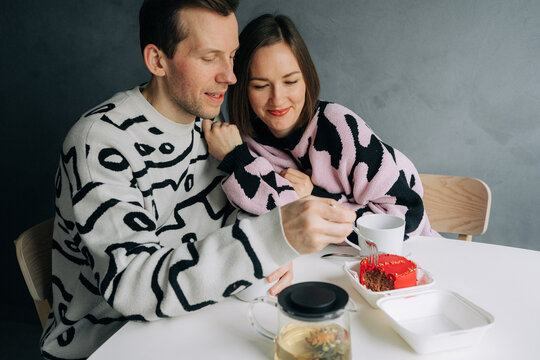 Couple Sharing Dessert and Tea at Table