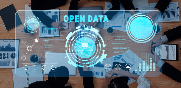 A group of professionals collaborates on open data strategies, surrounded by graphs and digital interfaces that represent analysis and data protection in a modern workspace. Trope