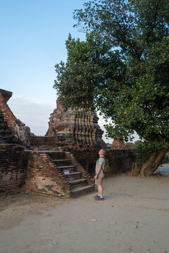 Male tourist visiting Wat Chaiwatthanaram, Ayutthaya, Thailand.