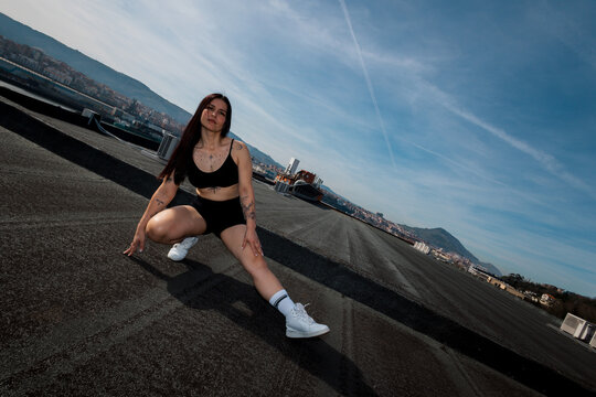 Female athlete stretching before workout outdoors