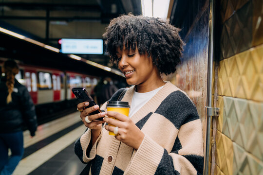 A woman using a mobile phone in the subway
