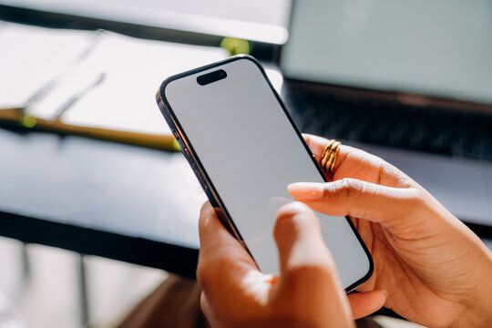 A woman using a mobile phone with a white screen