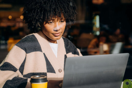 A woman using a laptop in a cafe