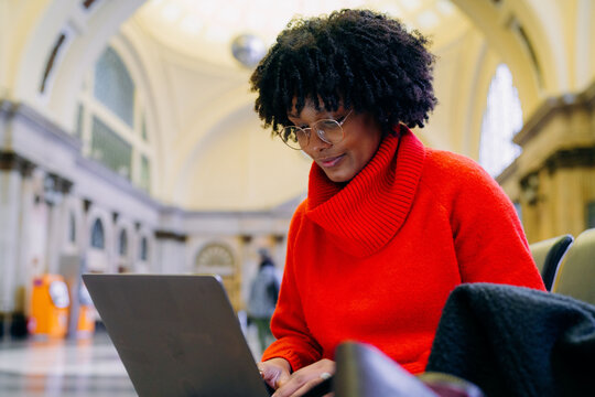 A woman uses a laptop in the waiting room