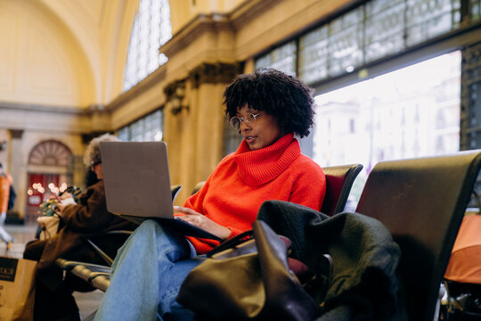 A woman uses a laptop in the waiting room