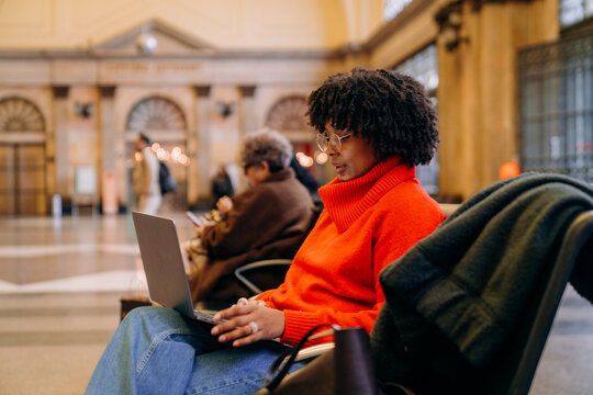 A woman uses a laptop in the waiting room