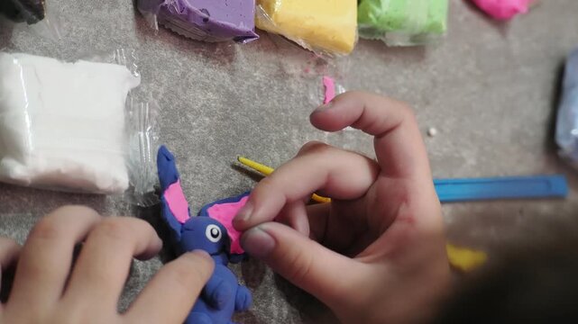 Little girls sculpt figurines crafts from air plasticine, modeling dough. Online lessons in tablet. Children's creativity hobby developing activities, training, learn of fine motor skills of hands.