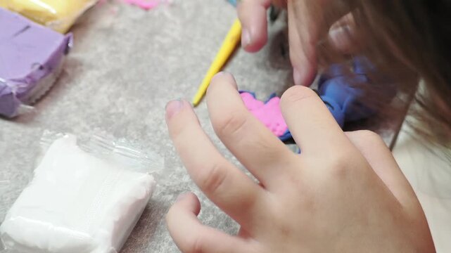 Little girls sculpt figurines crafts from air plasticine, modeling dough. Online lessons in tablet. Children's creativity hobby developing activities, training, learn of fine motor skills of hands.