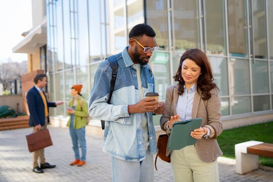 People discussing work outside a modern building