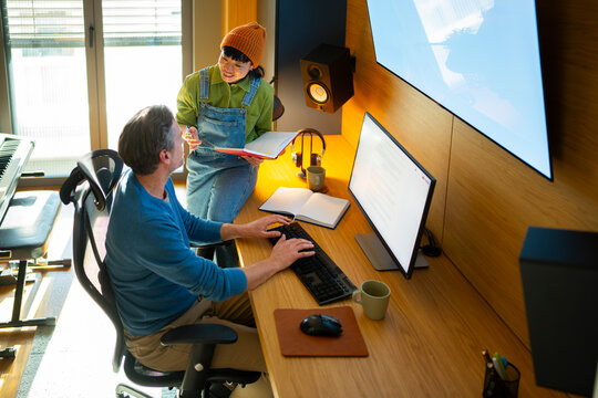 Creative professionals collaborating in home studio