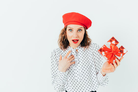 Young woman wearing red beret and polka-dot shirt