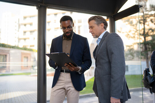 Business meeting at a bus stop 
