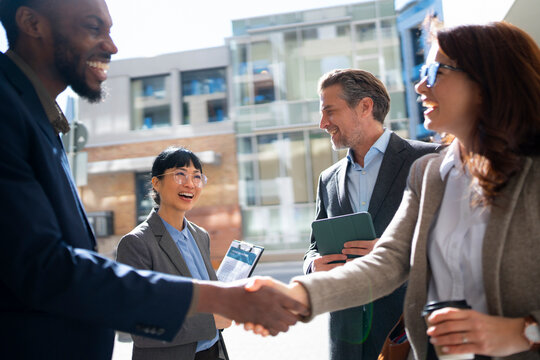 Business people meeting in urban area on sunny day
