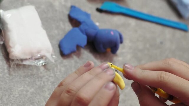 Little girls sculpt figurines crafts from air plasticine, modeling dough. Online lessons in tablet. Children's creativity hobby developing activities, training, learn of fine motor skills of hands.
